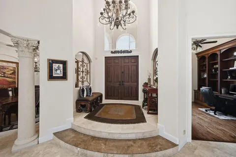 a living room with furniture a fireplace and a large window with outer view