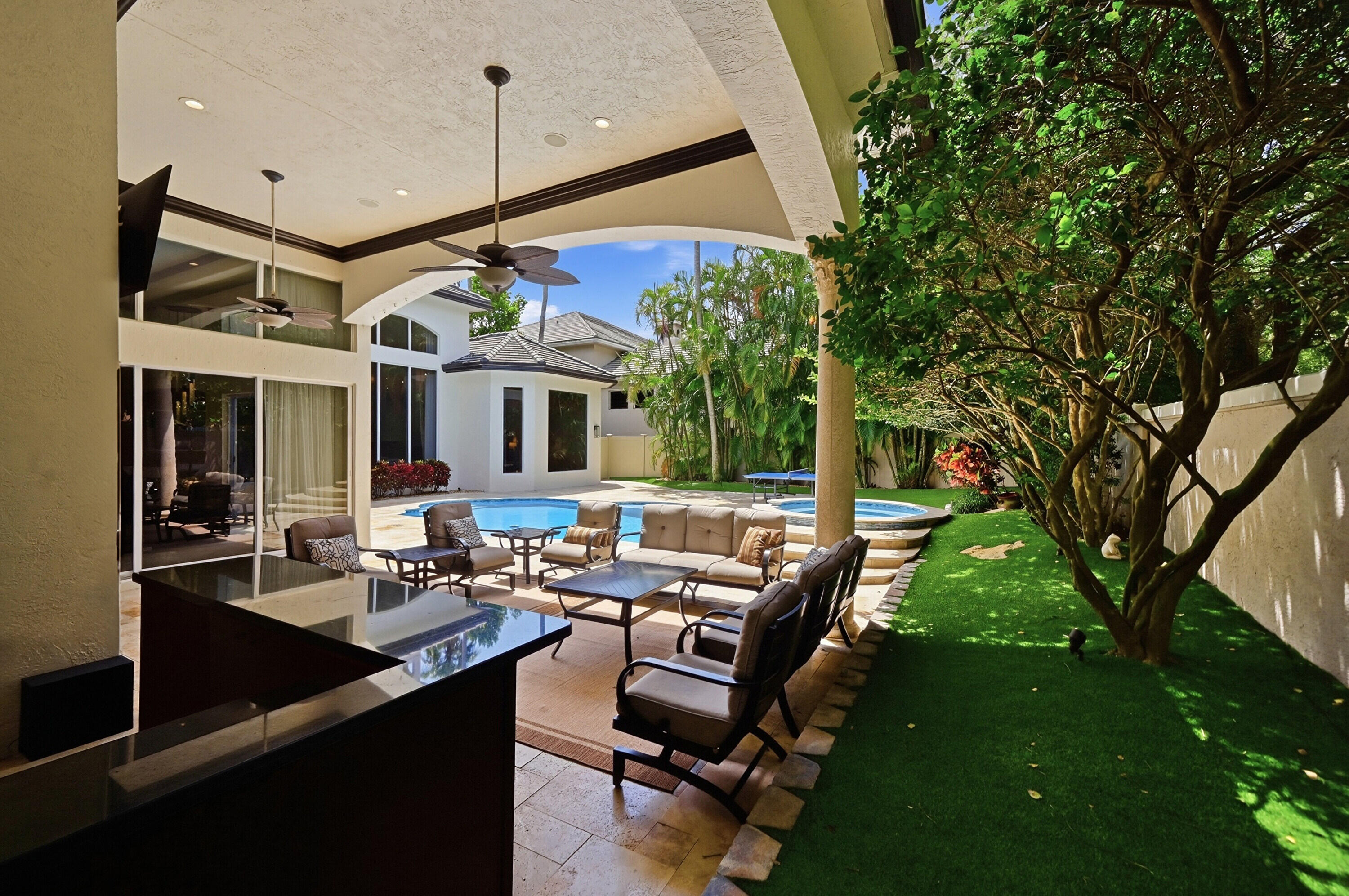 2425 Northwest 49th Lane Boca Raton, FL 33431 - Photo 45 of 46 a view of a patio with chairs and a grill
