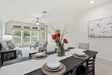 a dining room with furniture a potted plant and a fireplace