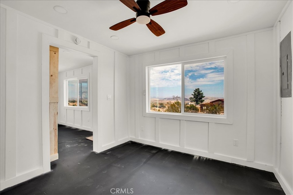 777 Quail Bush Road Landers, CA 92285 - Photo 14 of 46 a view of an empty room with window and a ceiling fan