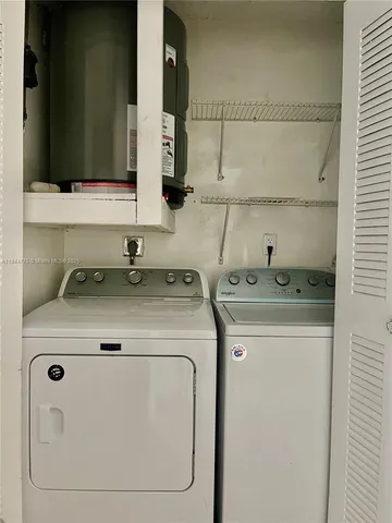 a kitchen with a sink a refrigerator and cabinets