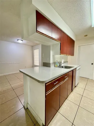 a kitchen with stainless steel appliances a refrigerator sink and microwave