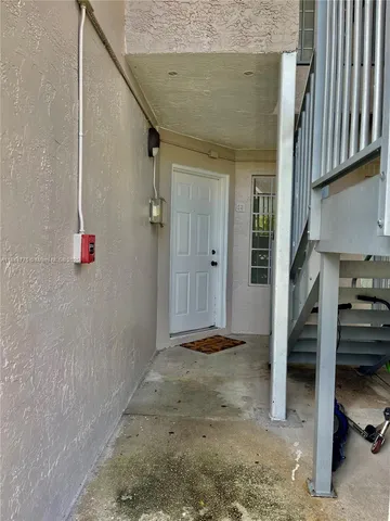 a view of staircase with lots of frames on wall