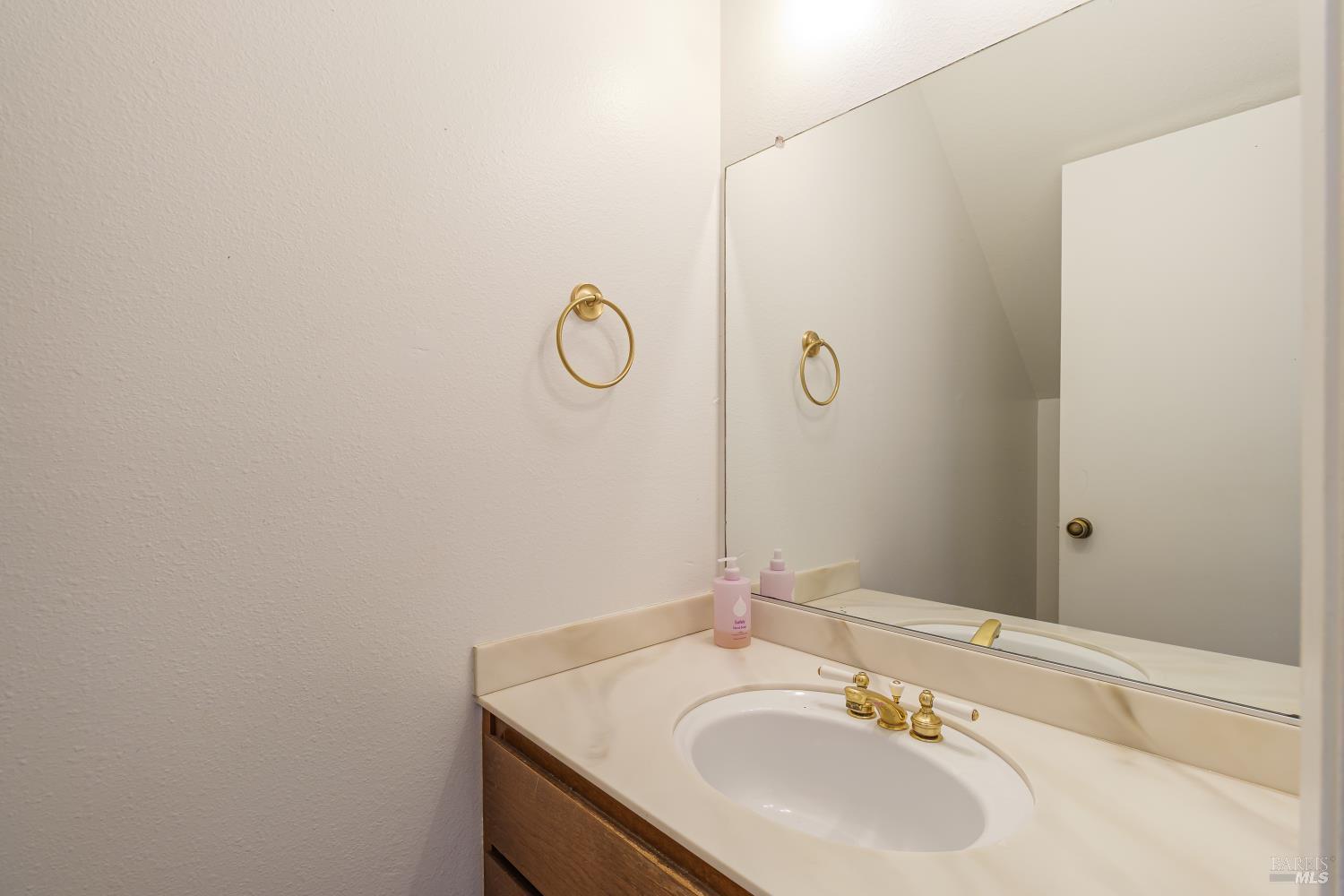 19 Burdell Court Novato, CA 94949 - Photo 12 of 27 a bathroom with a sink and a mirror