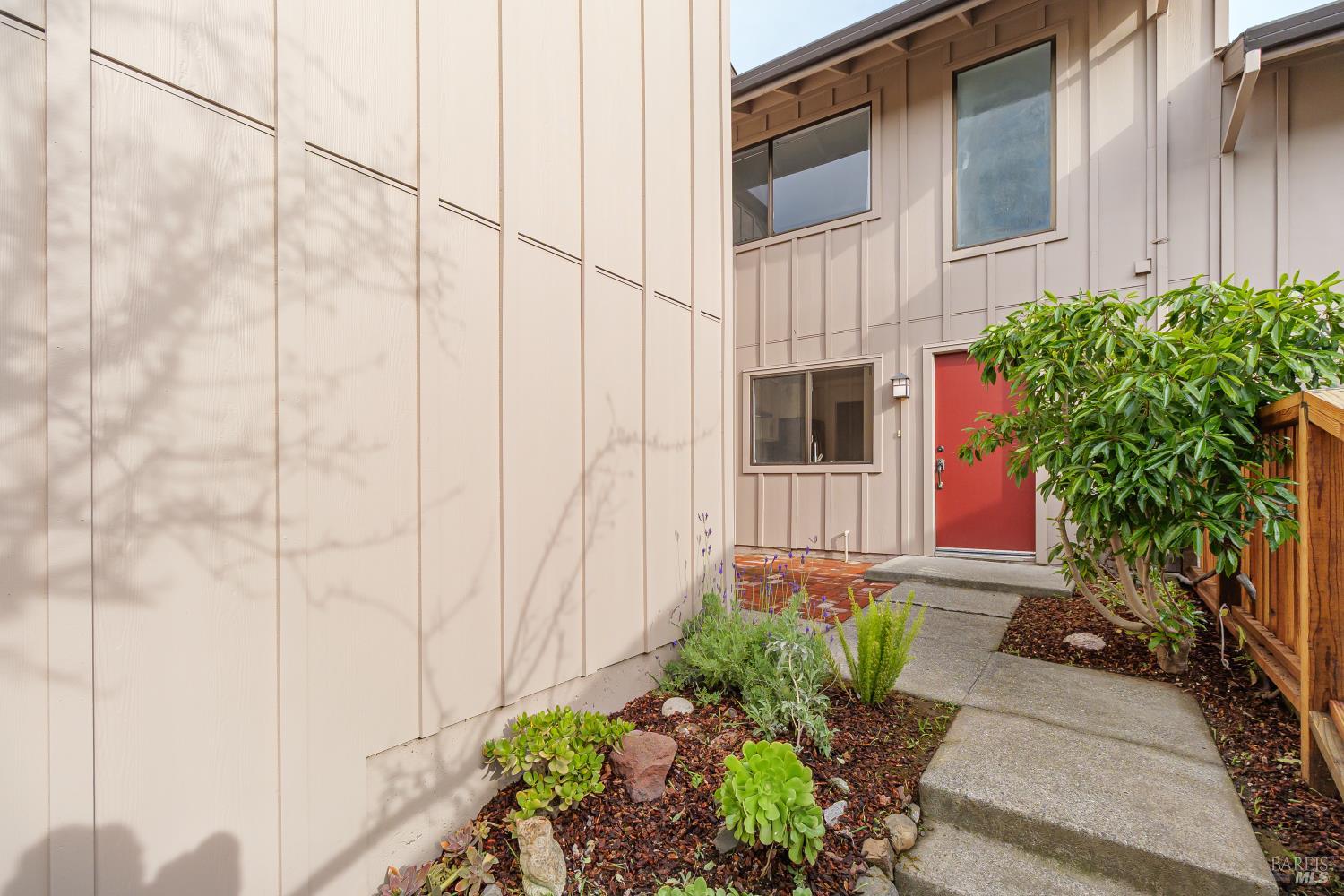19 Burdell Court Novato, CA 94949 - Photo 2 of 27 a view of a pathway along the house with potted plants