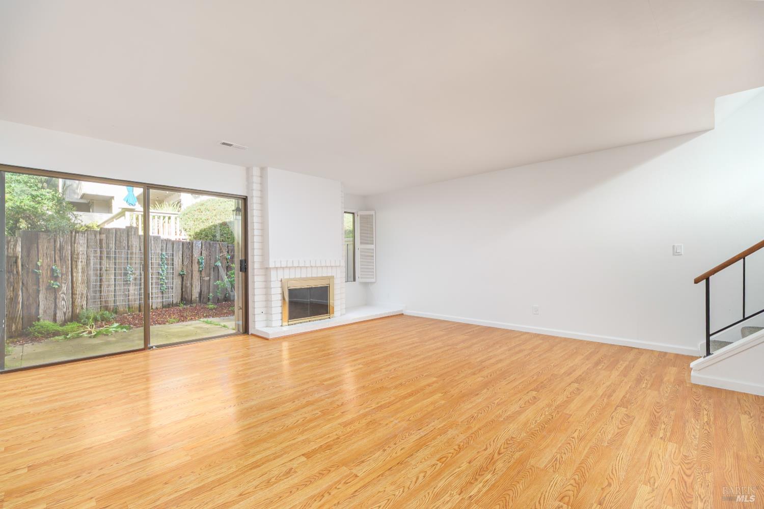 19 Burdell Court Novato, CA 94949 - Photo 10 of 27 a view of an empty room with wooden floor and a window