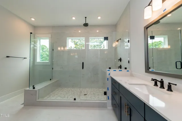 a bathroom with a tub a sink shower and mirror