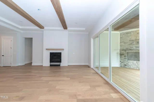 a view of an empty room with a fireplace