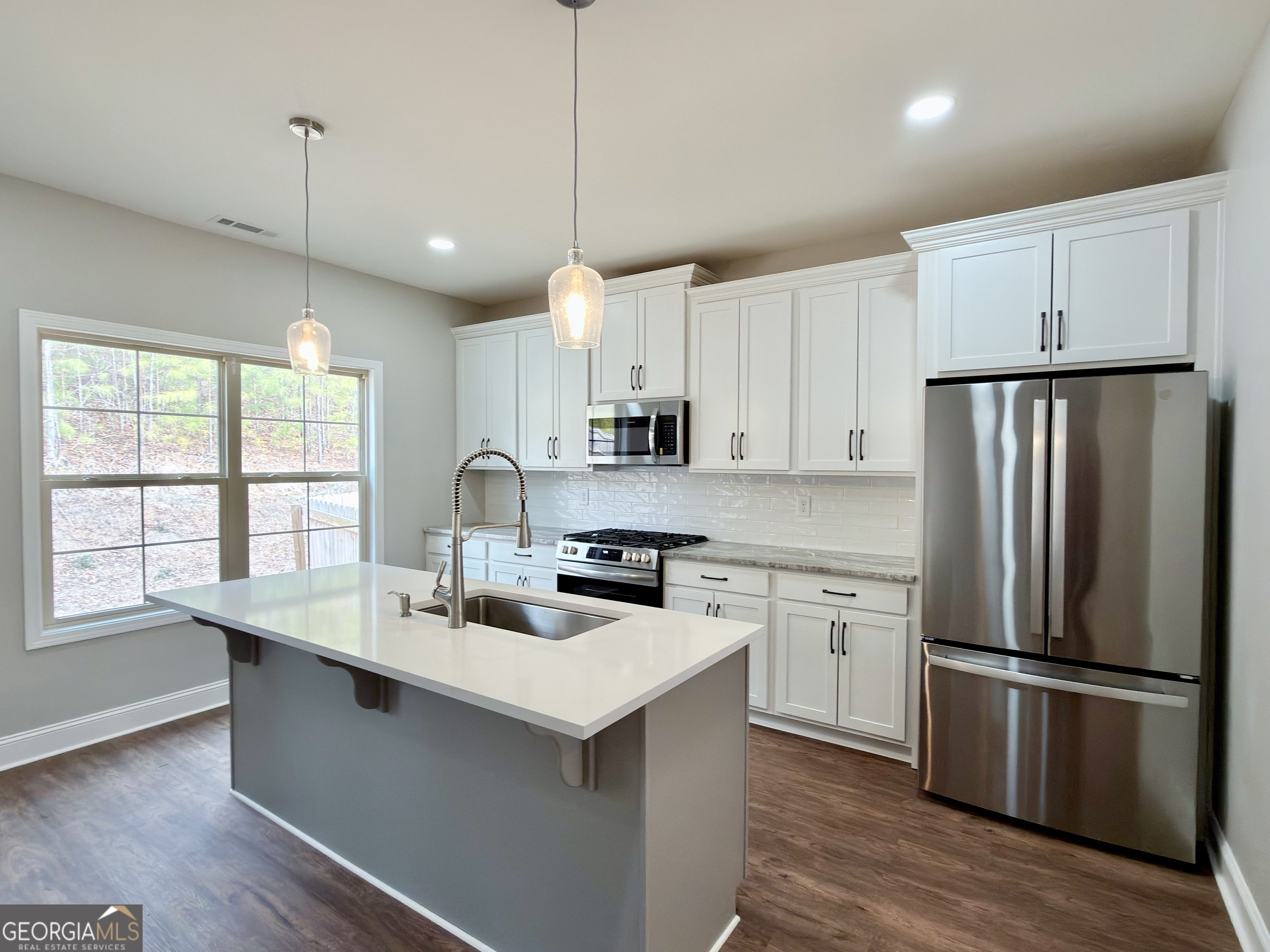 8 Bush Arbor Place Rome, GA 30165 - Photo 11 of 42 a kitchen with stainless steel appliances granite countertop a refrigerator a sink dishwasher a stove and white cabinets with wooden floor