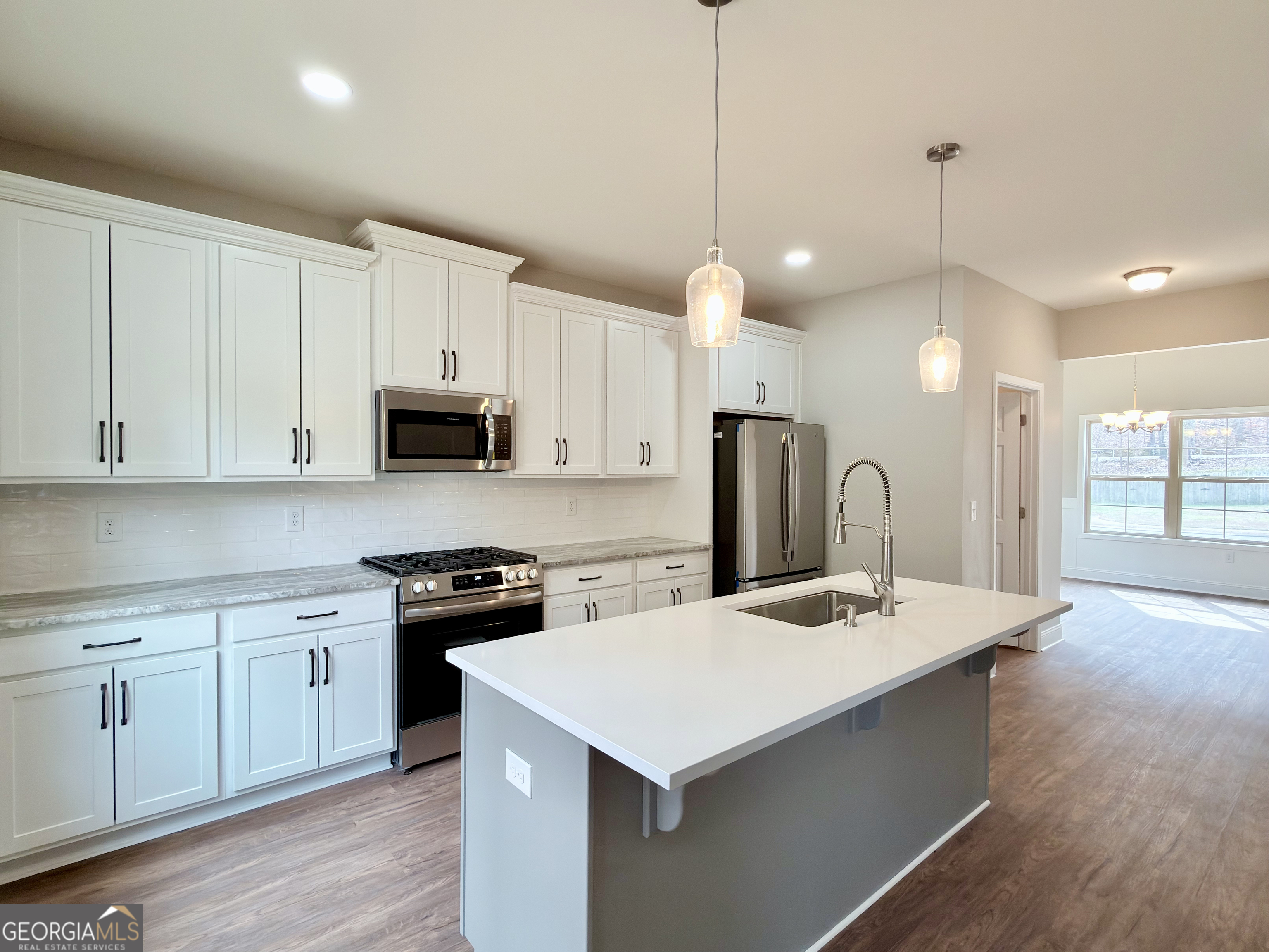 8 Bush Arbor Place Rome, GA 30165 - Photo 12 of 42 a kitchen that has a lot of cabinets and wooden floor