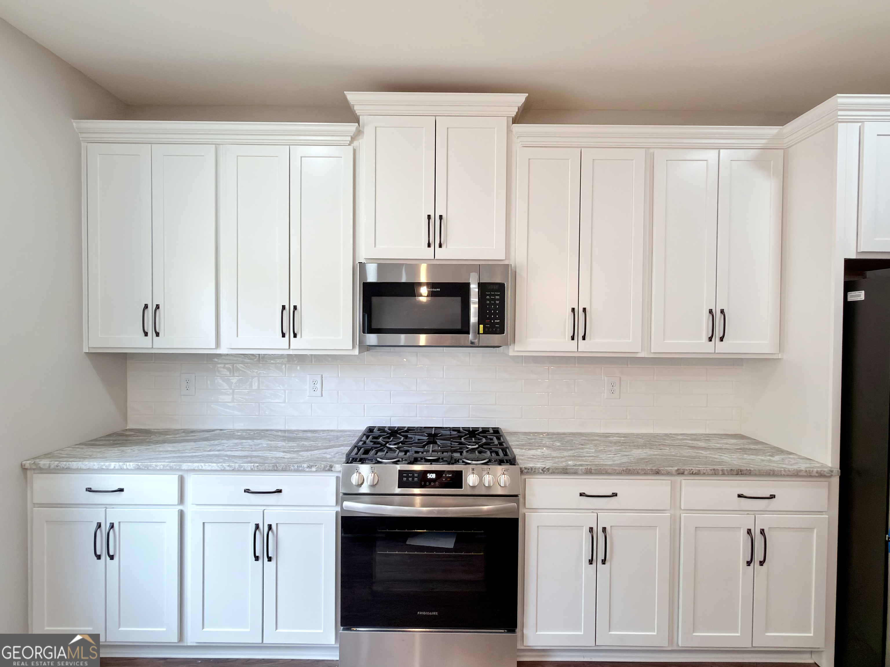8 Bush Arbor Place Rome, GA 30165 - Photo 14 of 42 a kitchen with granite countertop white cabinets and white appliances