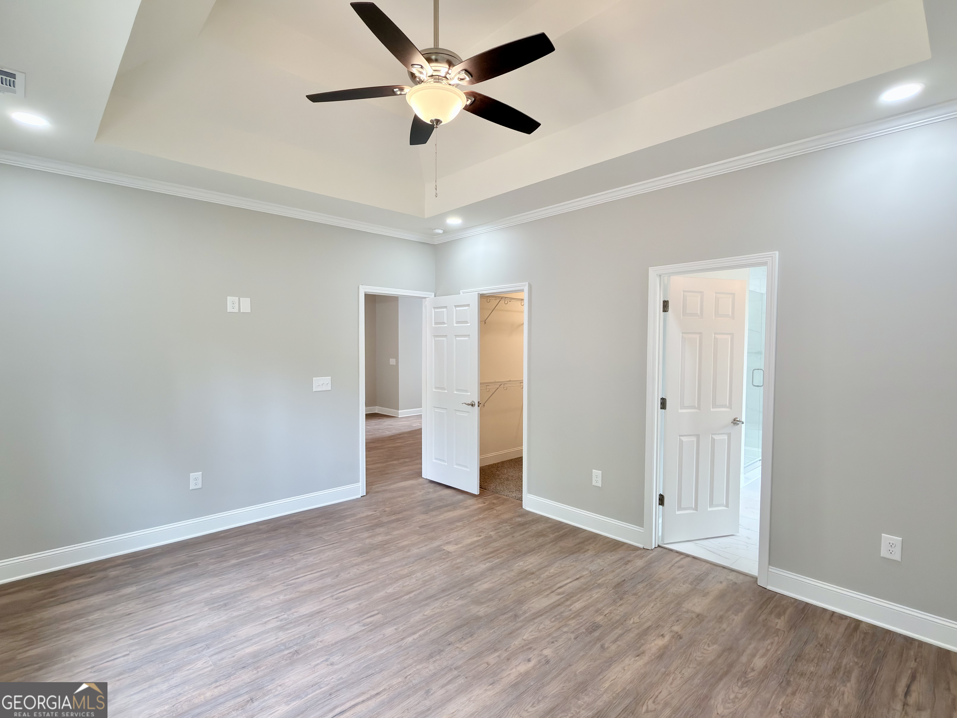 8 Bush Arbor Place Rome, GA 30165 - Photo 22 of 42 an empty room with wooden floor and ceiling fan