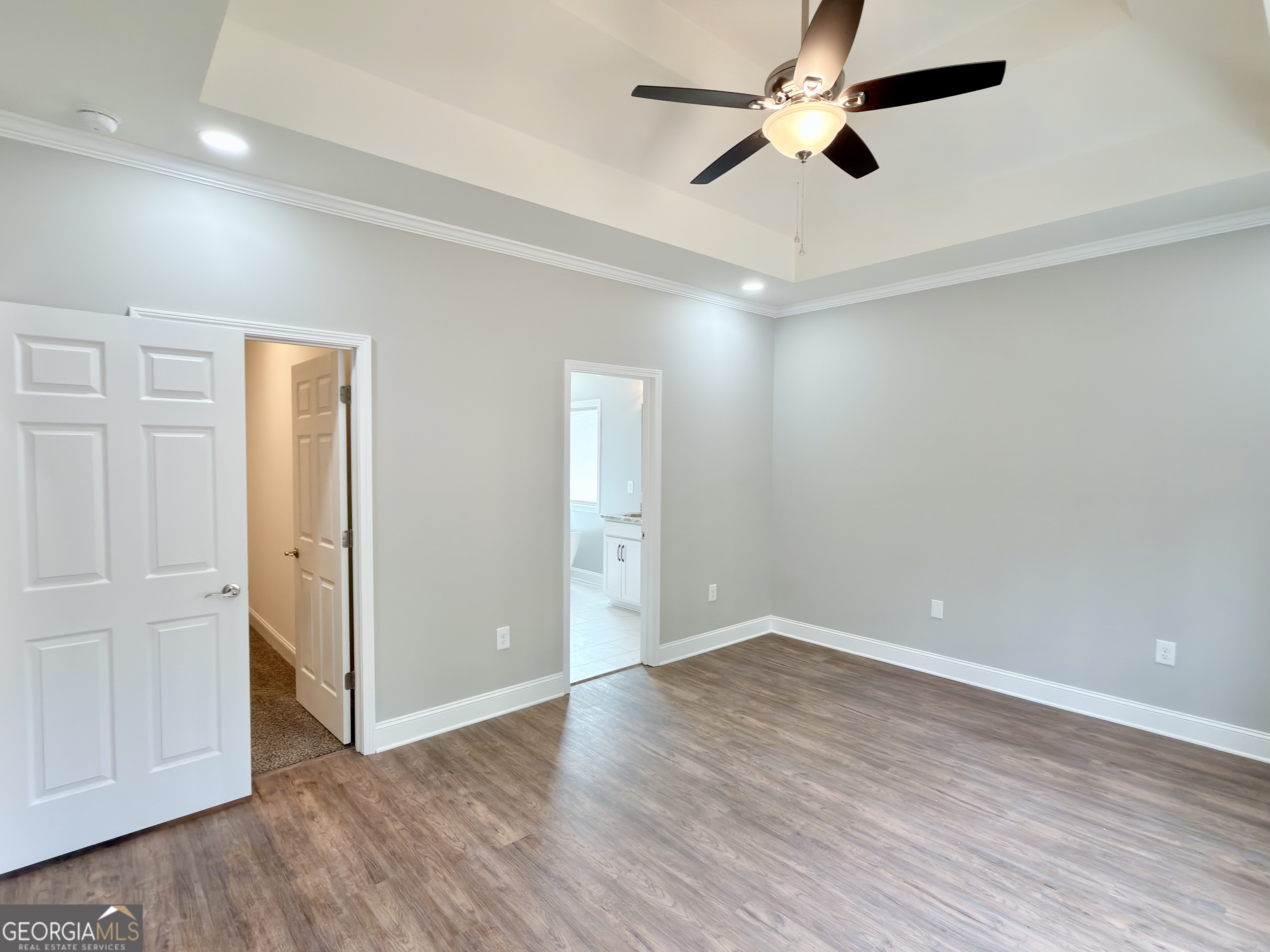 8 Bush Arbor Place Rome, GA 30165 - Photo 23 of 42 an empty room with wooden floor ceiling fan and windows