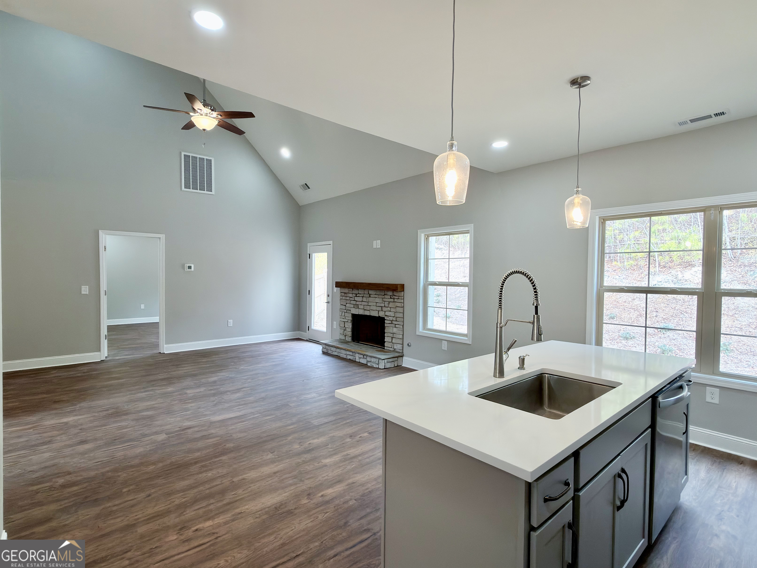 8 Bush Arbor Place Rome, GA 30165 - Photo 10 of 42 a kitchen with a sink a fireplace and a chandelier