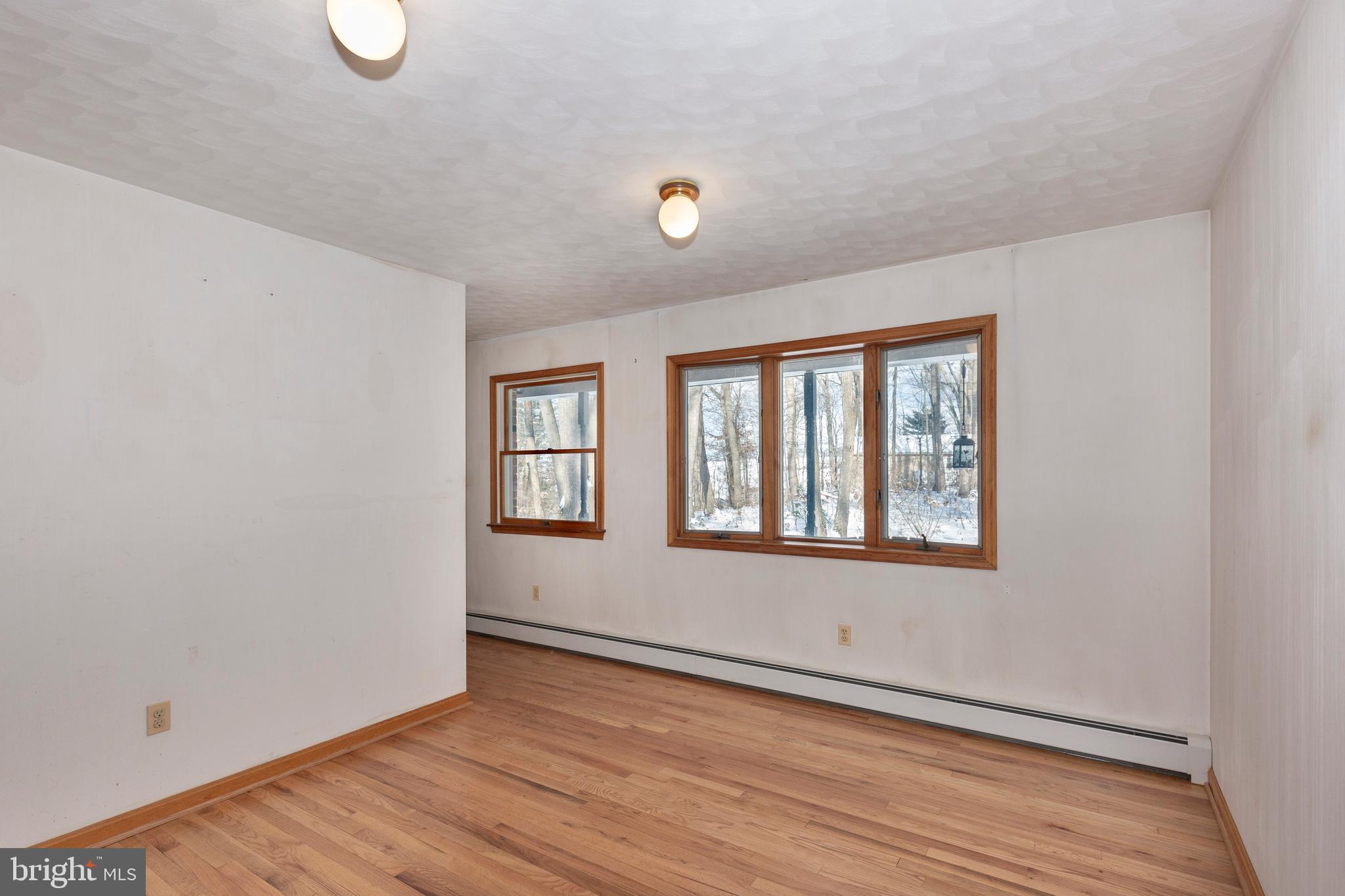 4437 Dave Rill Road Hampstead, MD 21074 - Photo 18 of 68 an empty room with wooden floor and windows