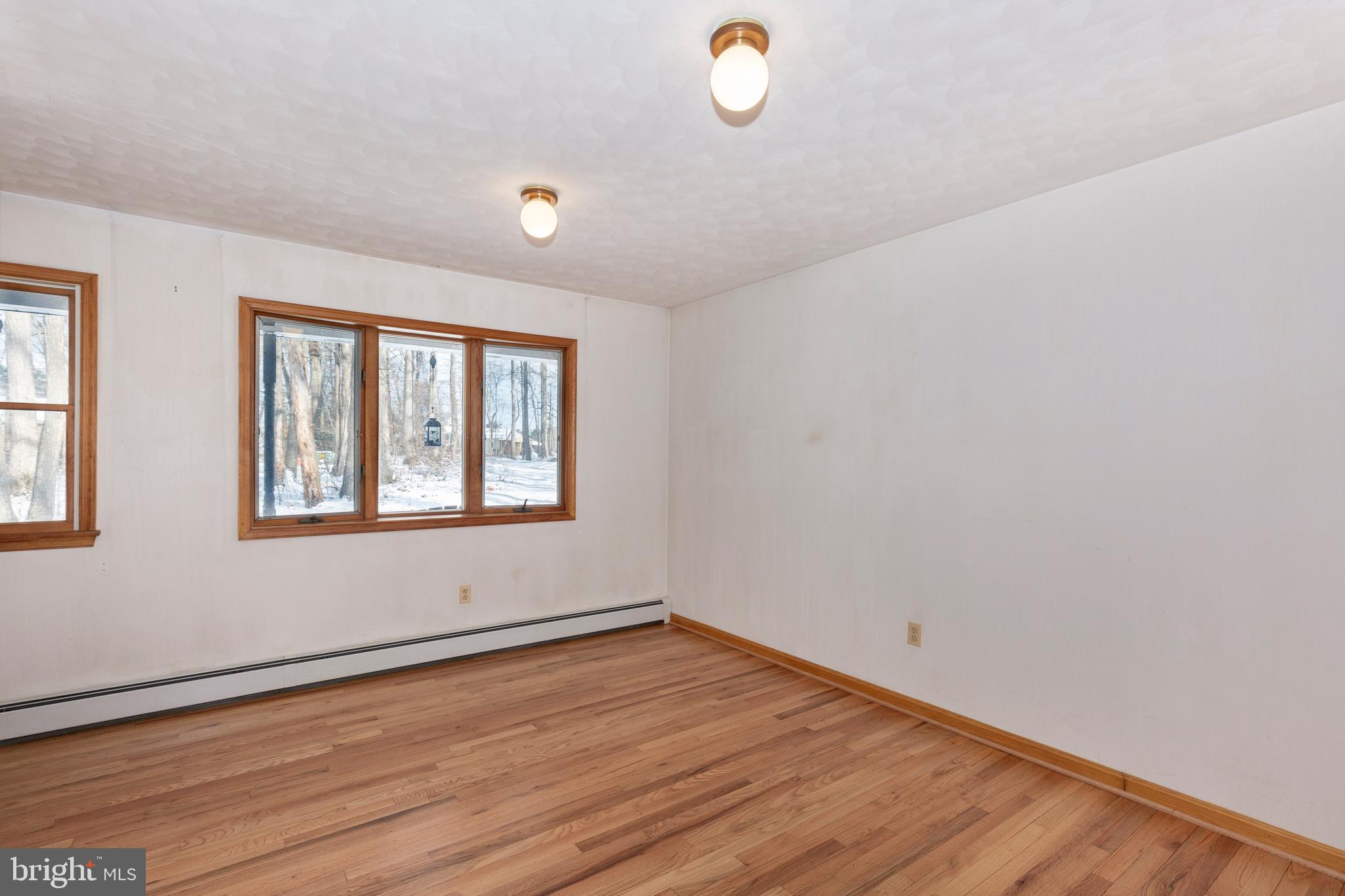 4437 Dave Rill Road Hampstead, MD 21074 - Photo 19 of 68 wooden floor in an empty room with a window