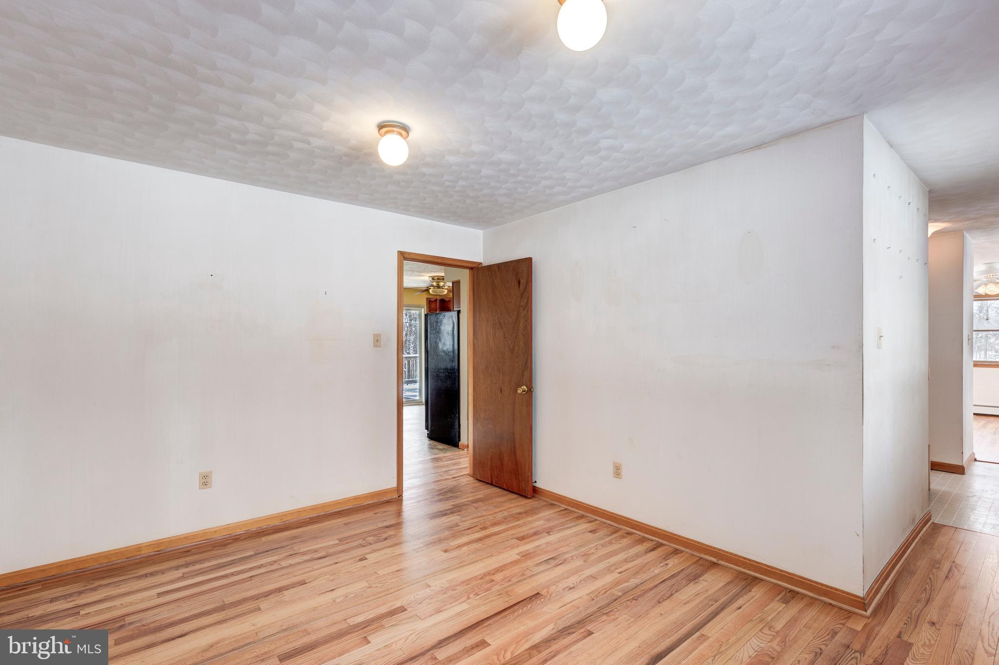 4437 Dave Rill Road Hampstead, MD 21074 - Photo 20 of 68 a view of an empty room with wooden floor and a window