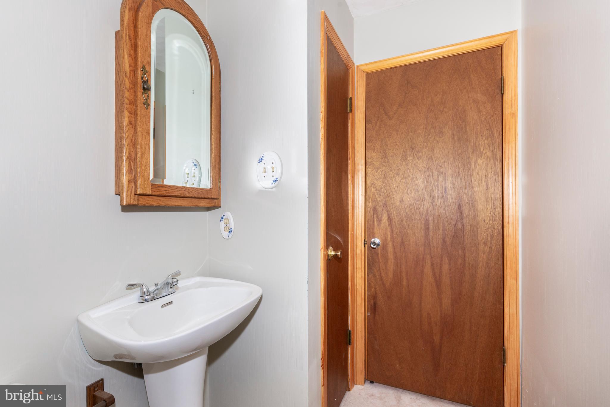 4437 Dave Rill Road Hampstead, MD 21074 - Photo 27 of 68 a bathroom with a sink and a mirror