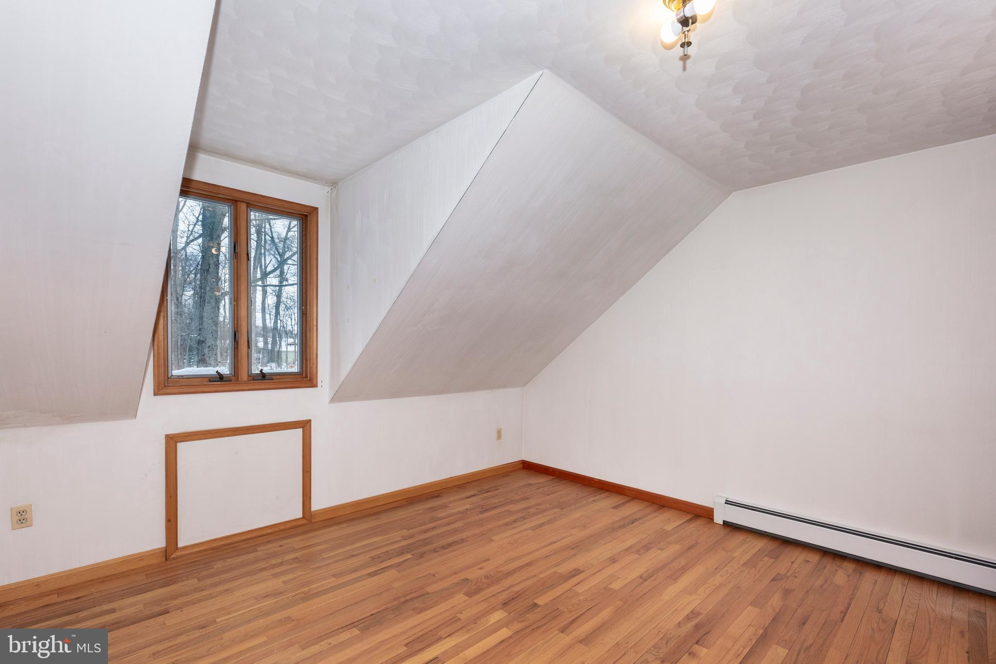 4437 Dave Rill Road Hampstead, MD 21074 - Photo 36 of 68 an empty room with wooden floor and windows