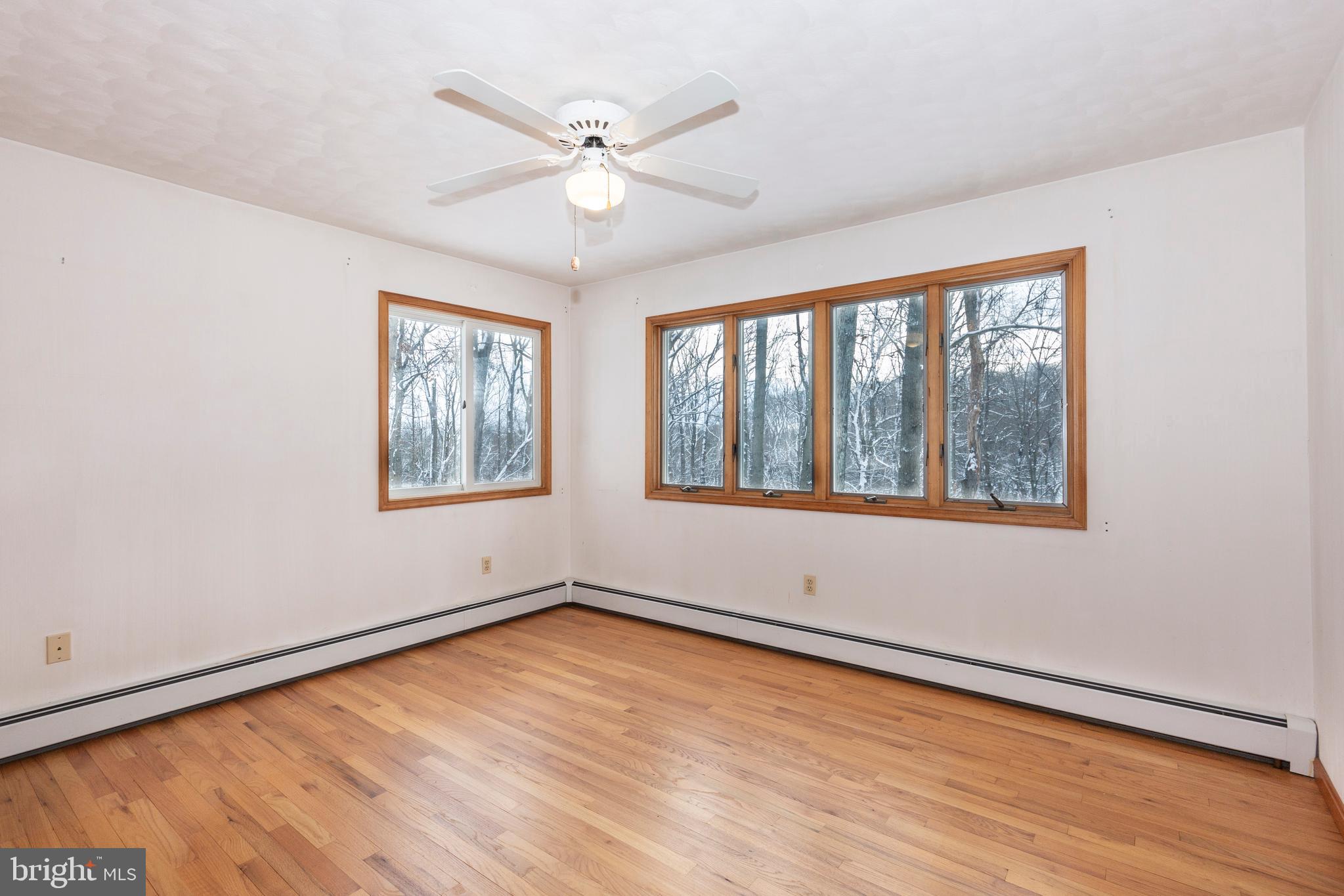 4437 Dave Rill Road Hampstead, MD 21074 - Photo 39 of 68 a view of an empty room with wooden floor and a window