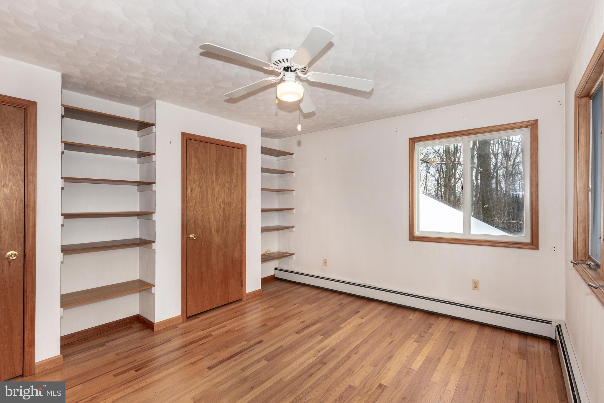4437 Dave Rill Road Hampstead, MD 21074 - Photo 40 of 68 a view of an empty room with a window and wooden floor