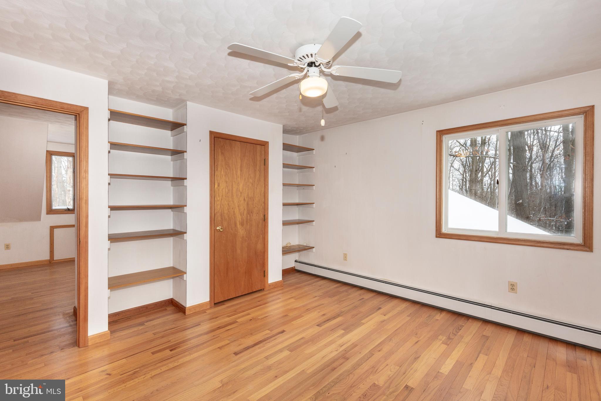 4437 Dave Rill Road Hampstead, MD 21074 - Photo 41 of 68 a view of an empty room with a window and wooden floor