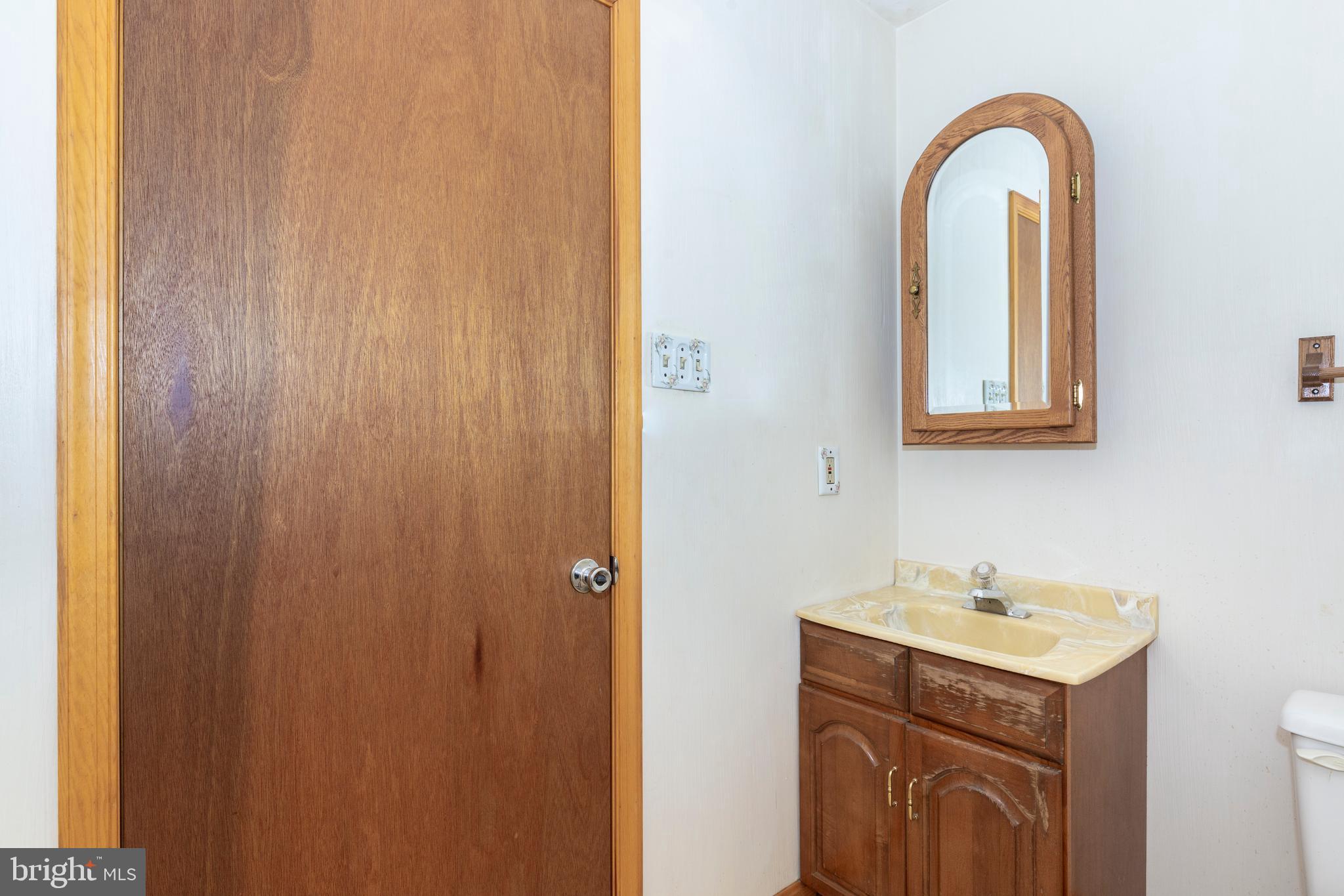 4437 Dave Rill Road Hampstead, MD 21074 - Photo 42 of 68 a bathroom with a sink and a mirror