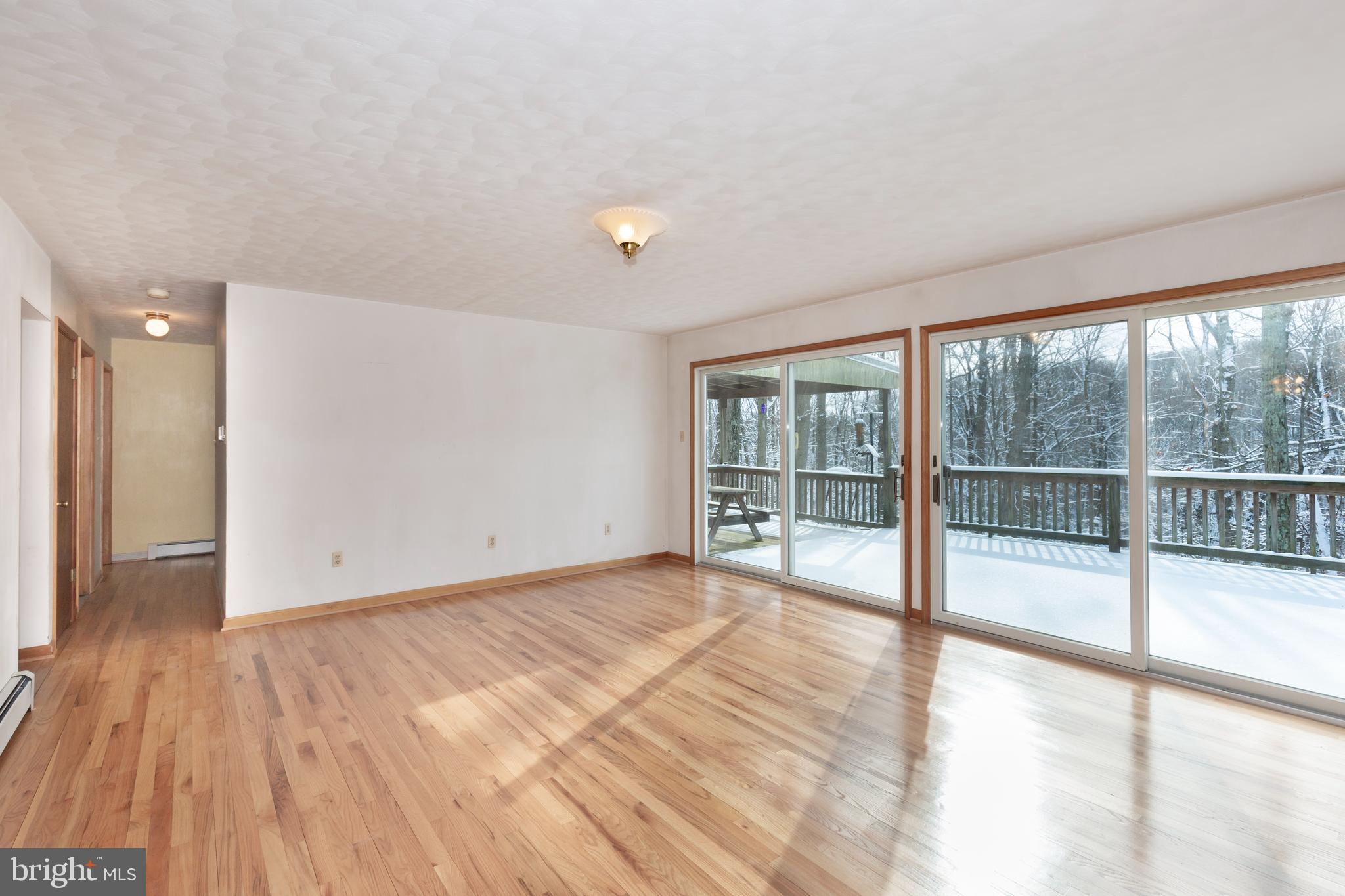 4437 Dave Rill Road Hampstead, MD 21074 - Photo 5 of 68 a view of an empty room with wooden floor and a window