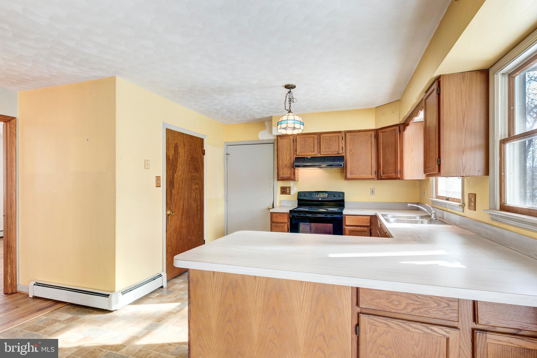 4437 Dave Rill Road Hampstead, MD 21074 - Photo 7 of 68 a kitchen with stainless steel appliances a sink counter space and a window