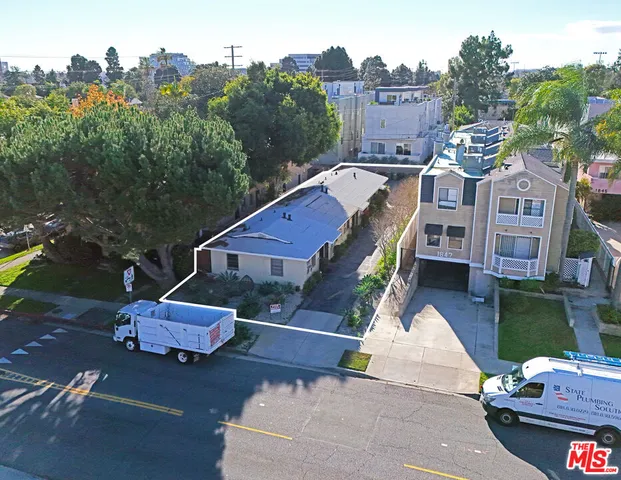 an aerial view of a house with a garden and lake view