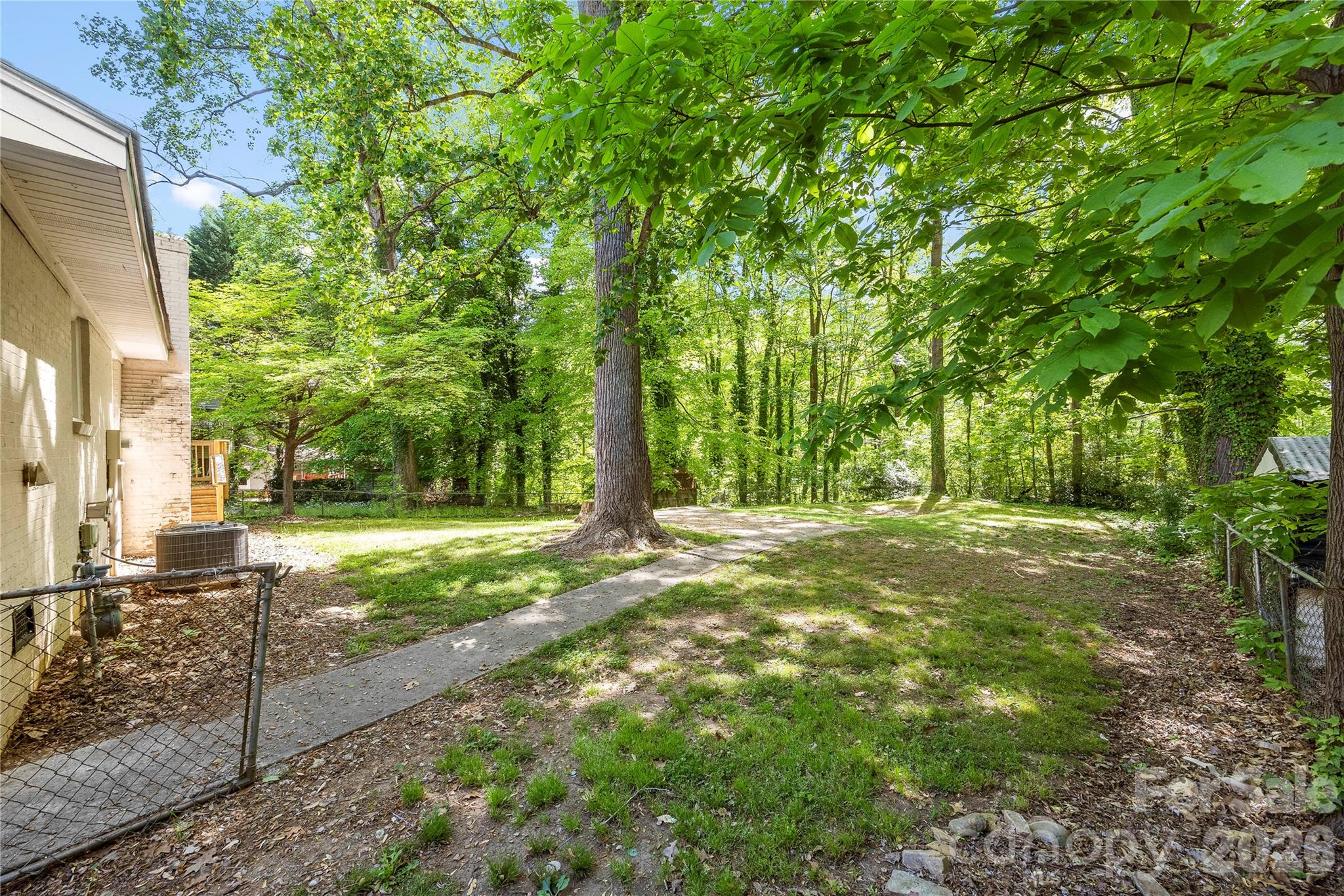 7001 Crossridge Road Charlotte, NC 28214 - Photo 14 of 30 a view of a yard with plants and trees