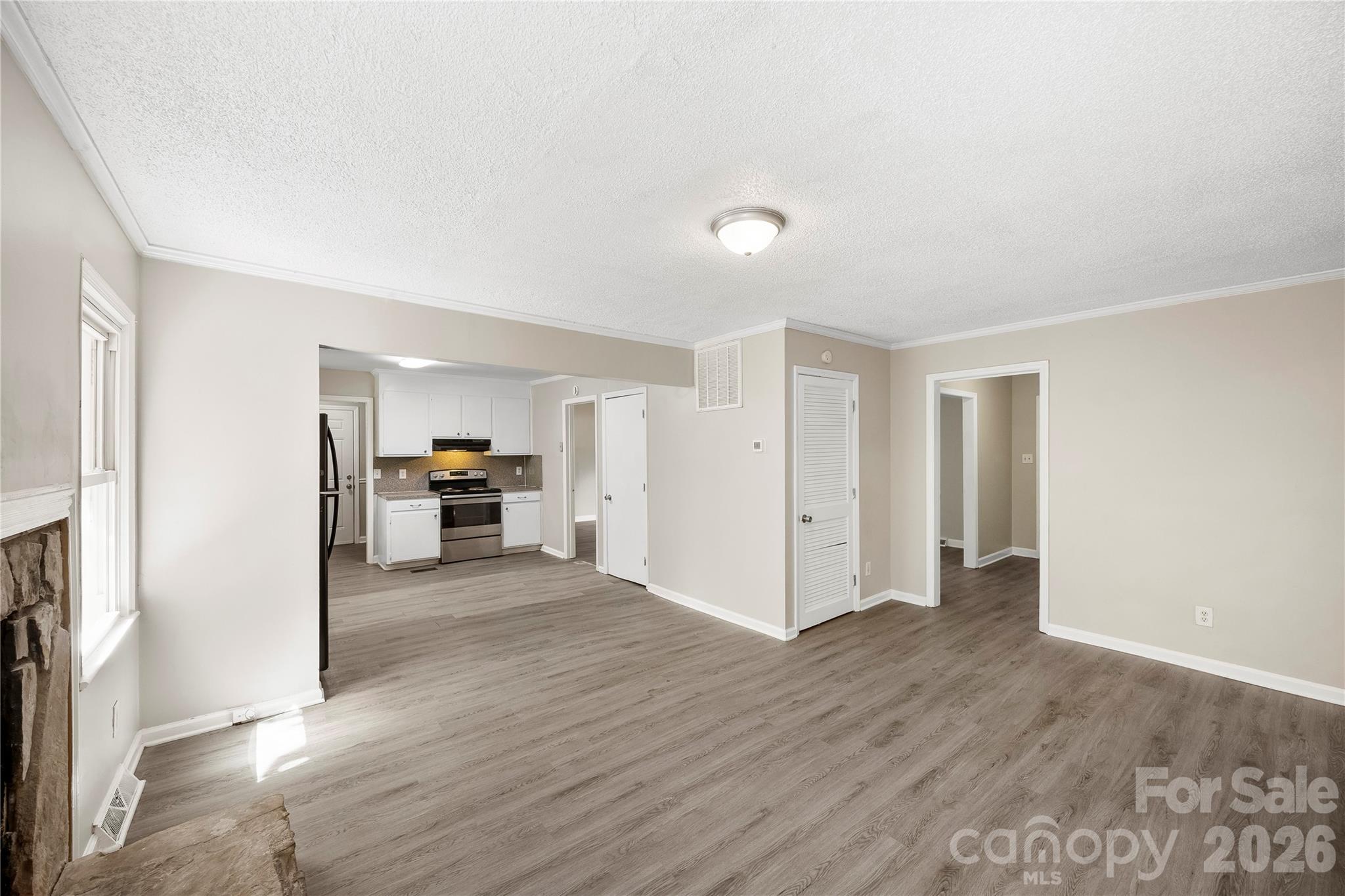 7001 Crossridge Road Charlotte, NC 28214 - Photo 20 of 30 a view of a livingroom with wooden floor and a refrigerator