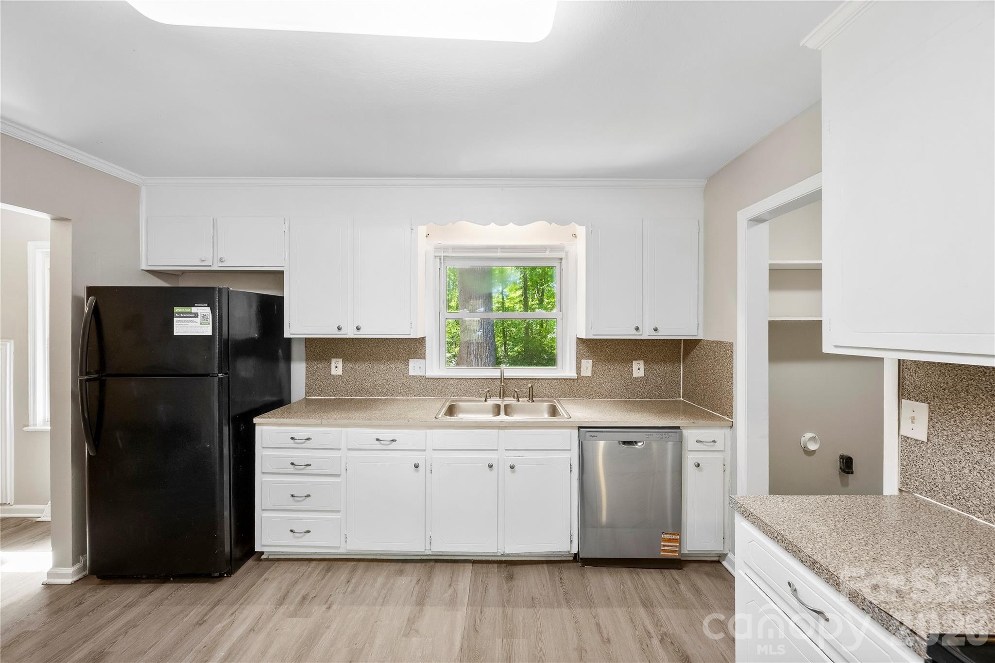7001 Crossridge Road Charlotte, NC 28214 - Photo 2 of 30 a kitchen with a sink stove and refrigerator