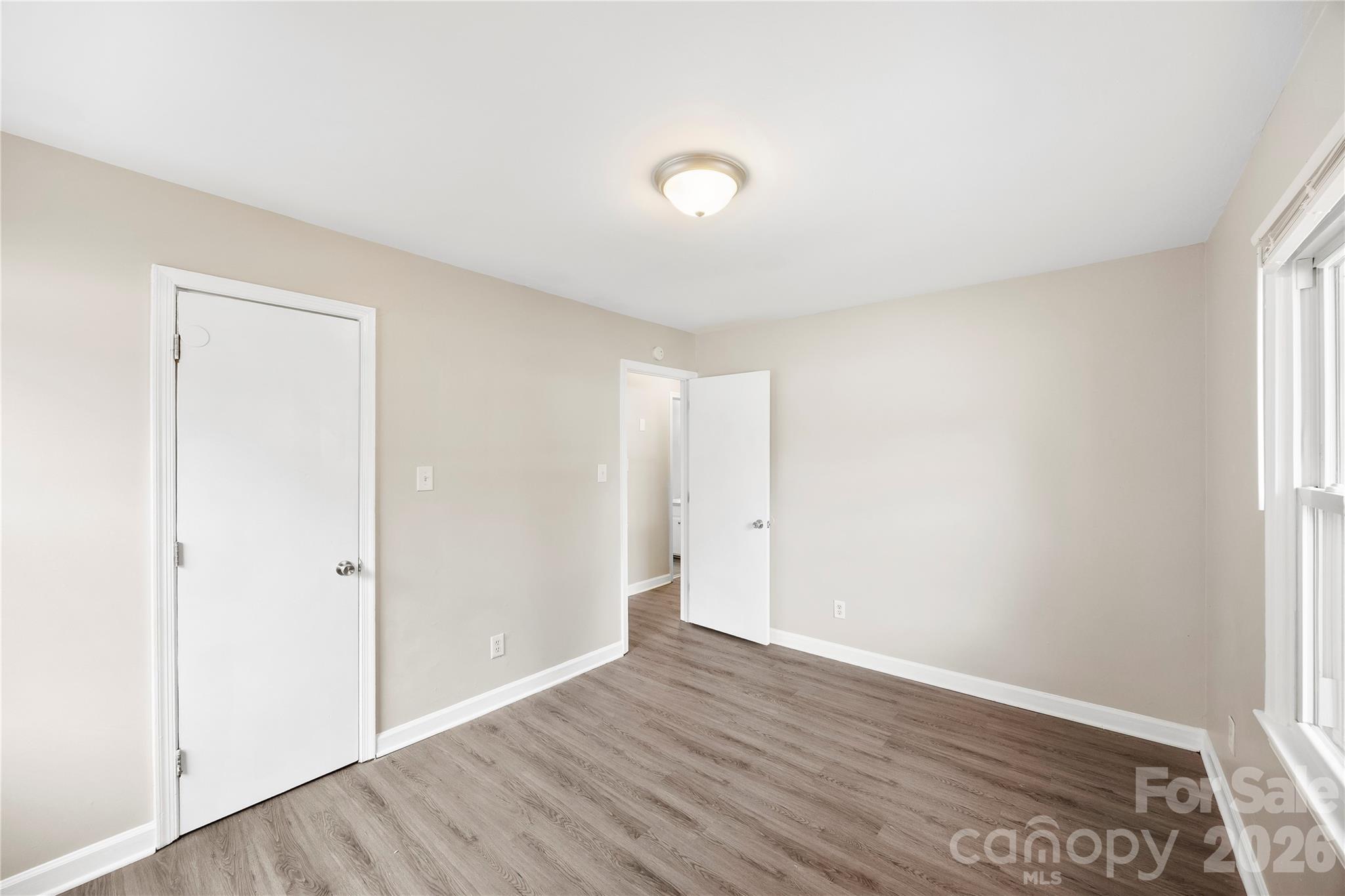7001 Crossridge Road Charlotte, NC 28214 - Photo 22 of 30 an empty room with wooden floor