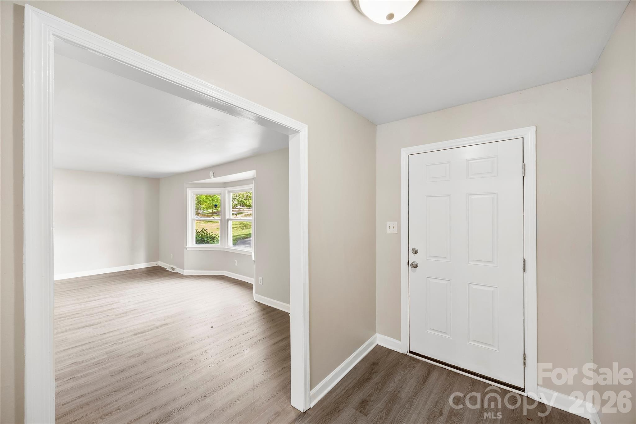 7001 Crossridge Road Charlotte, NC 28214 - Photo 23 of 30 an empty room with wooden floor and windows