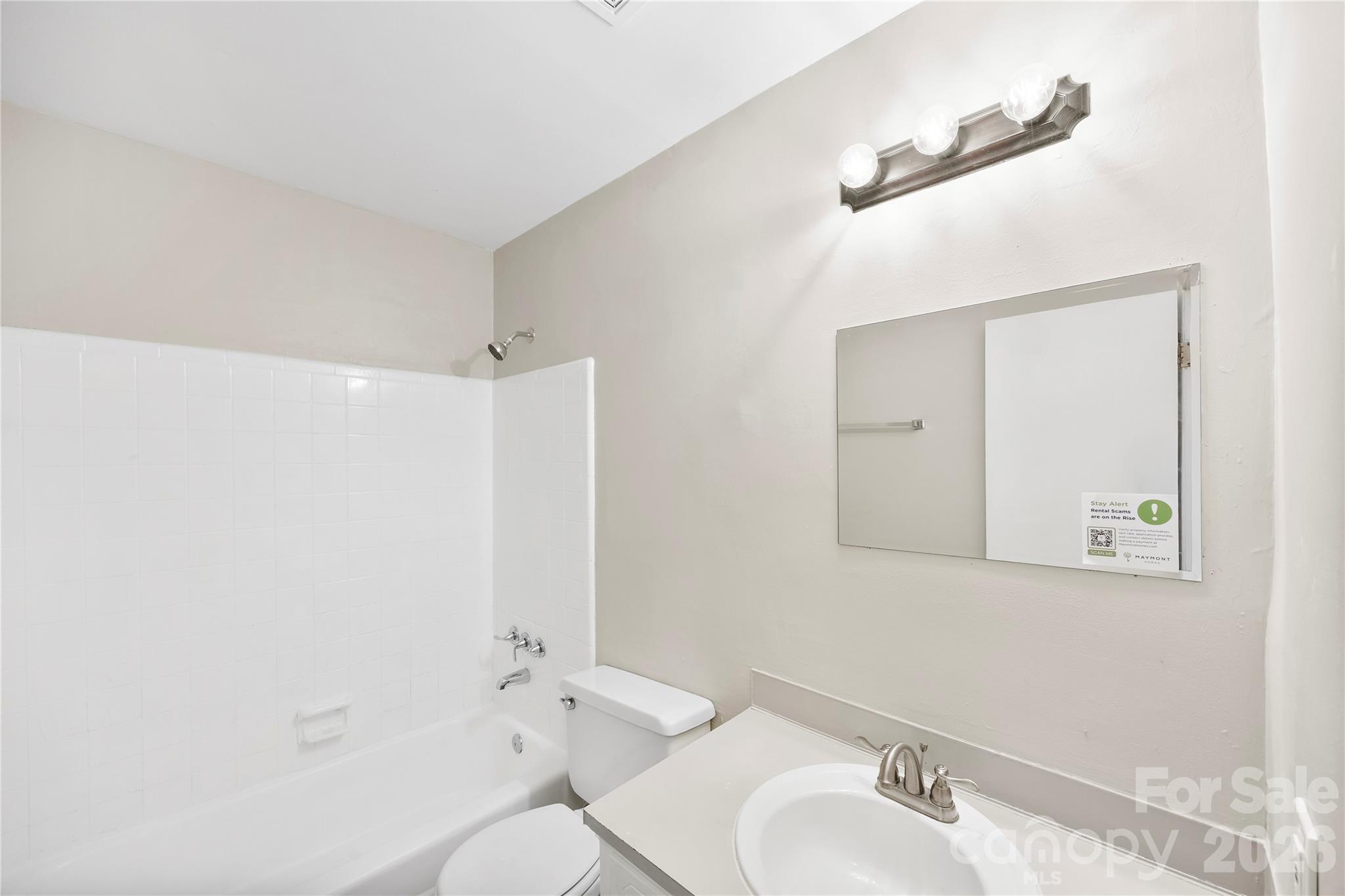 7001 Crossridge Road Charlotte, NC 28214 - Photo 26 of 30 a bathroom with a sink mirror and a toilet