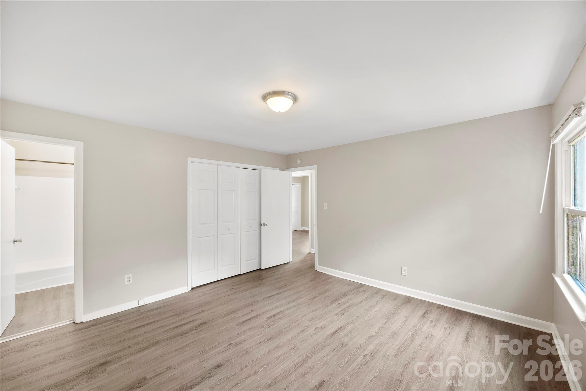7001 Crossridge Road Charlotte, NC 28214 - Photo 27 of 30 an empty room with wooden floor and windows