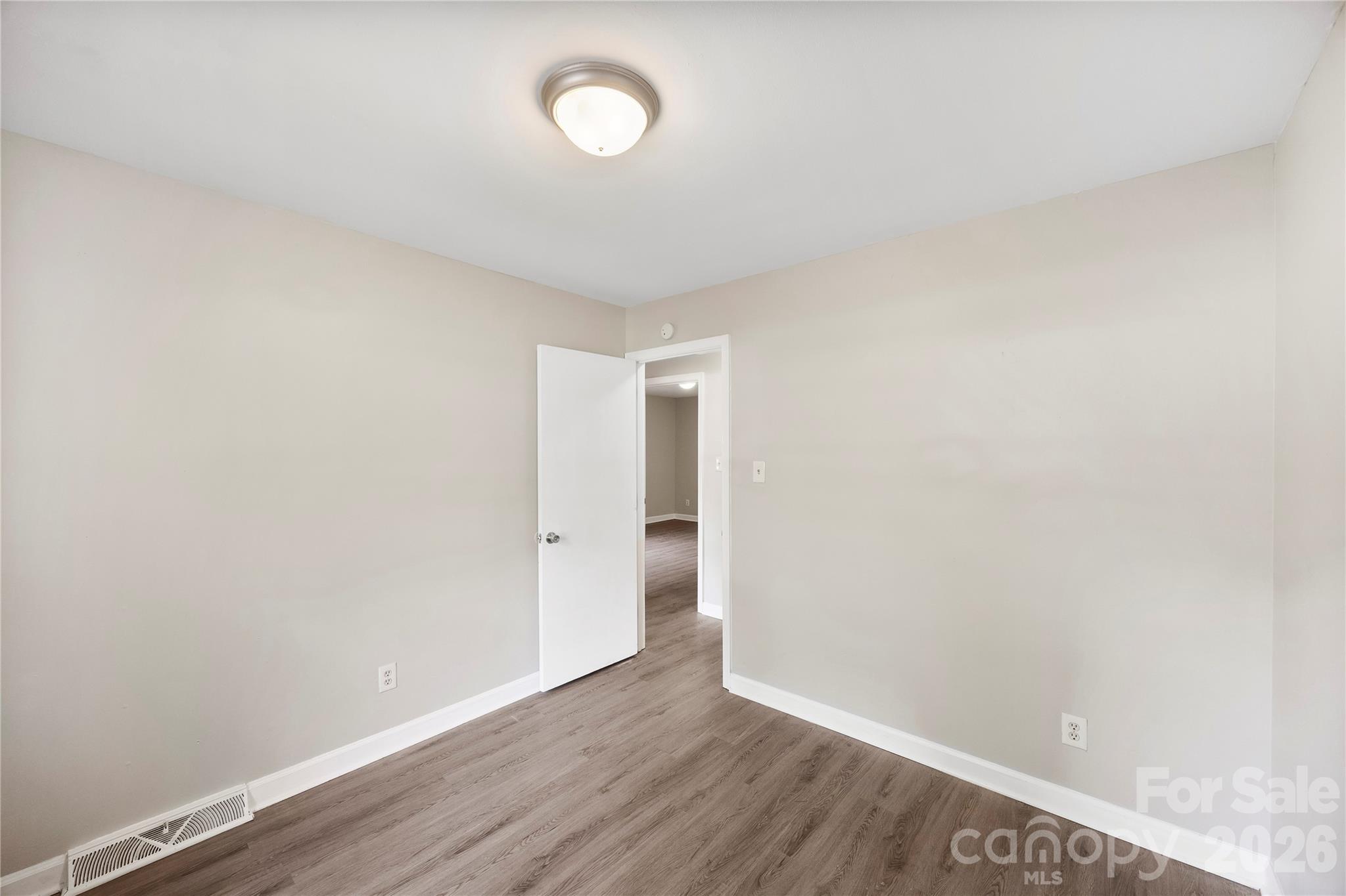 7001 Crossridge Road Charlotte, NC 28214 - Photo 29 of 30 a view of an empty room with wooden floor