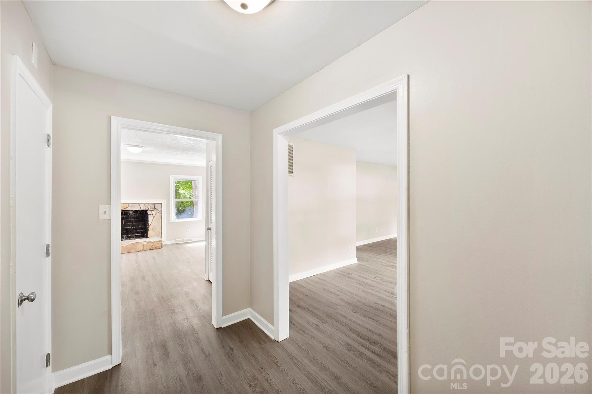 7001 Crossridge Road Charlotte, NC 28214 - Photo 6 of 30 a view of a hallway with wooden floor