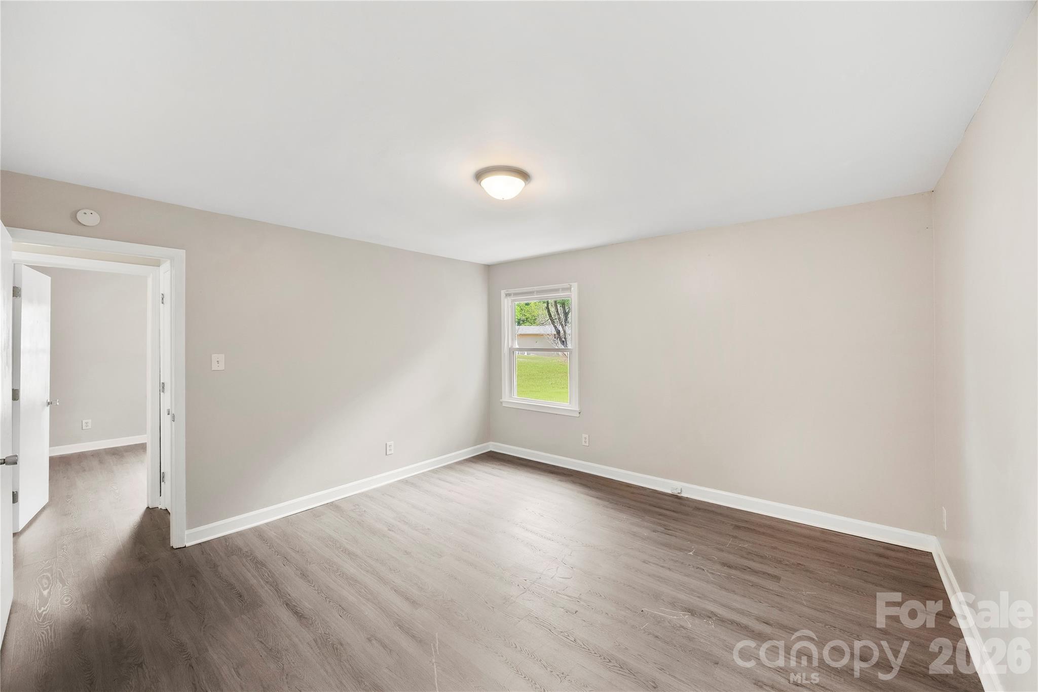 7001 Crossridge Road Charlotte, NC 28214 - Photo 9 of 30 wooden floor in an empty room with a window