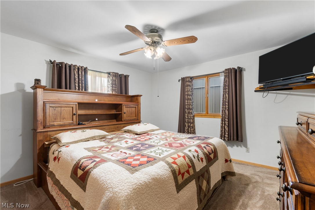 22840 Buck Road Alliance, OH 44601 - Photo 13 of 36 Carpeted bedroom featuring a ceiling fan and baseboards