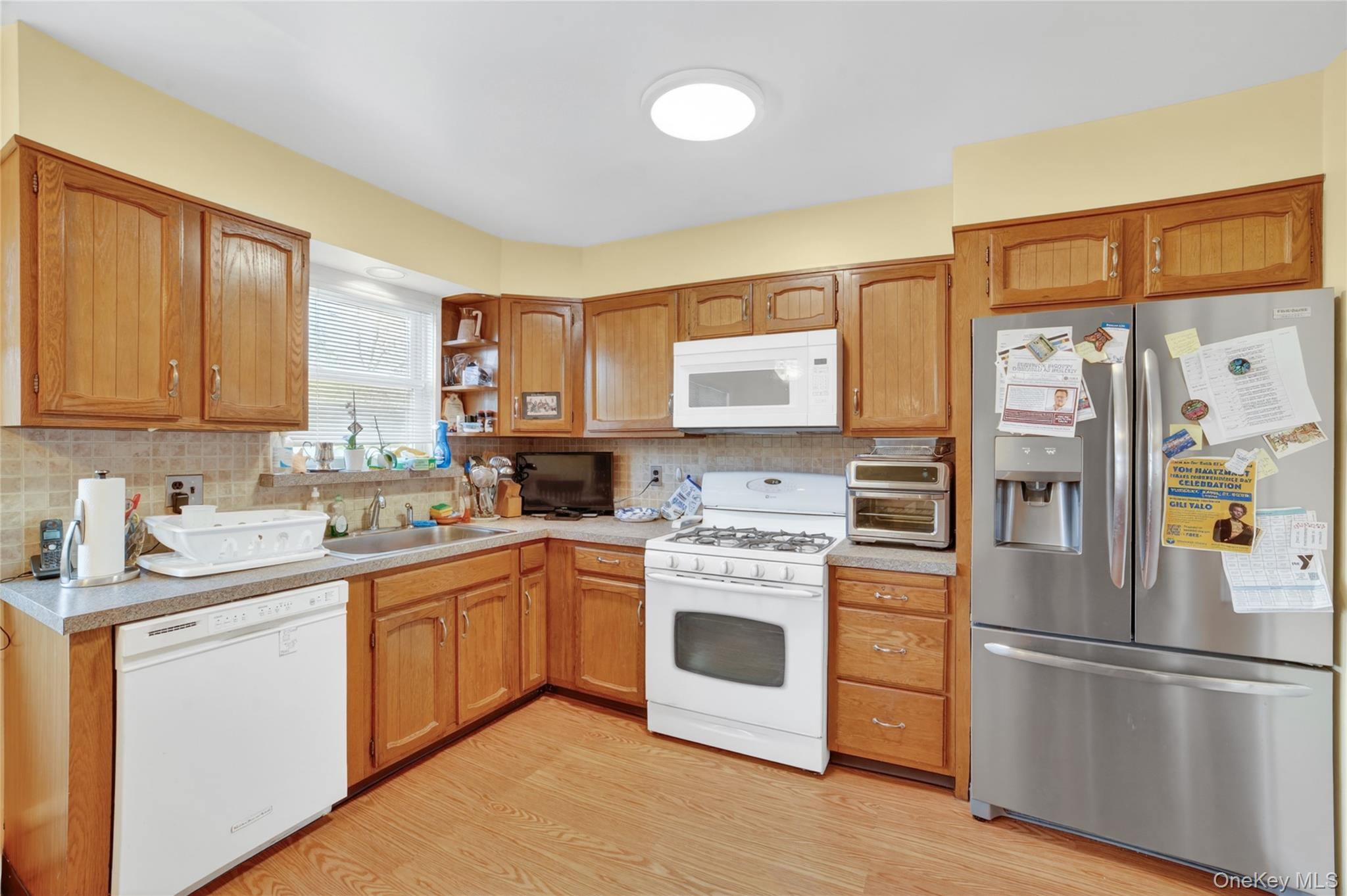 276 5th Avenue New Rochelle, NY 10801 - Photo 13 of 40 a kitchen with a white cabinets and white appliances