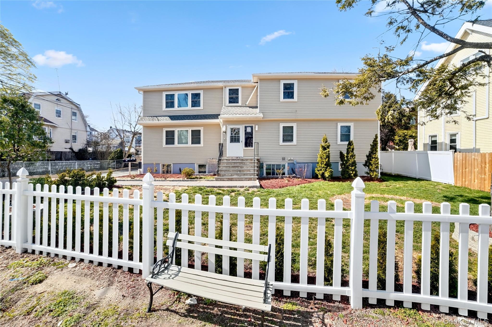 276 5th Avenue New Rochelle, NY 10801 - Photo 2 of 40 a front view of white house with a fence