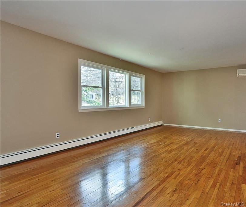 276 5th Avenue New Rochelle, NY 10801 - Photo 22 of 40 a view of an empty room with wooden floor and a window