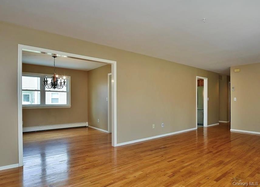 276 5th Avenue New Rochelle, NY 10801 - Photo 23 of 40 a view of an empty room with wooden floor and a window