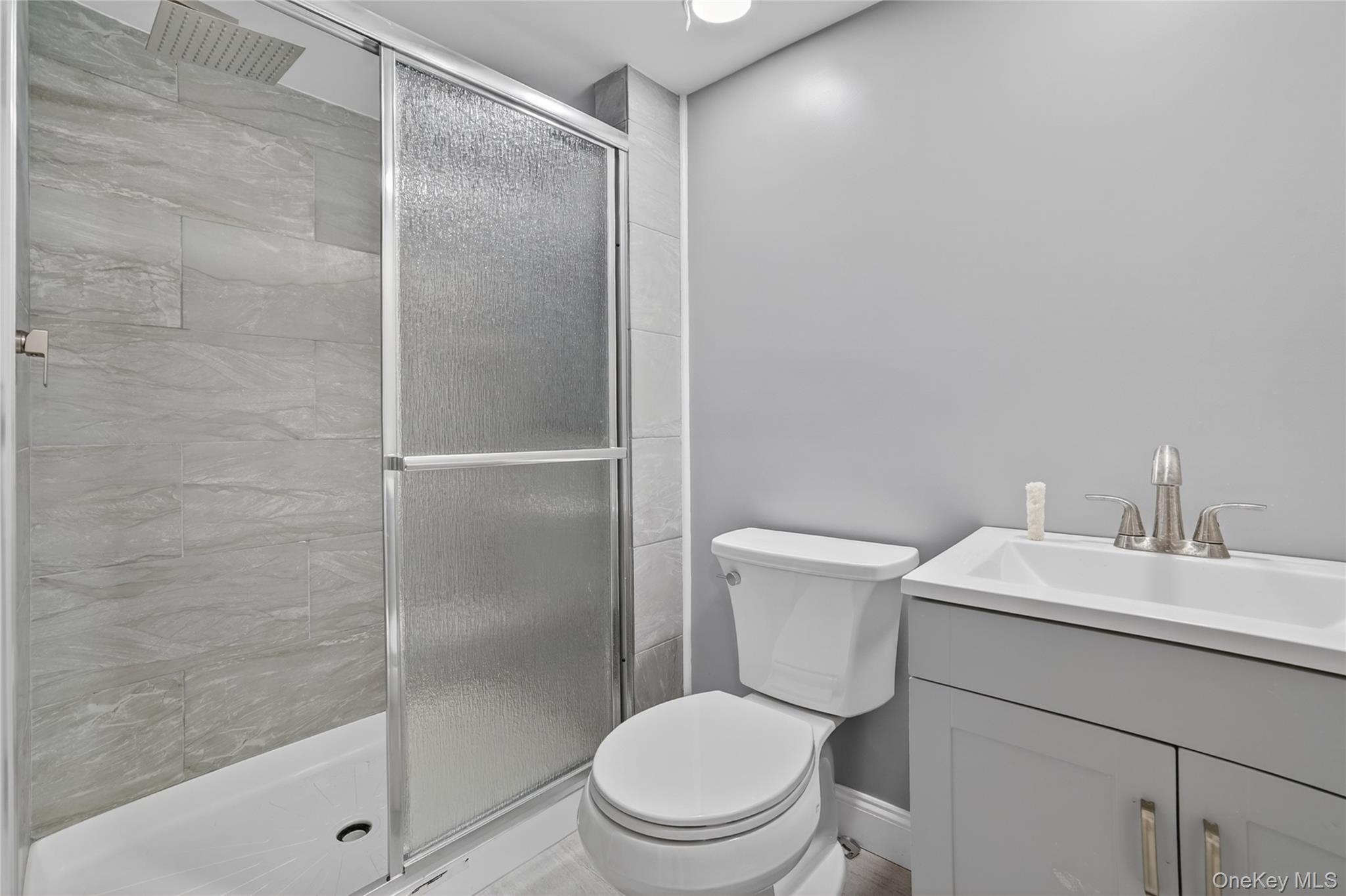 276 5th Avenue New Rochelle, NY 10801 - Photo 27 of 40 a bathroom with a toilet a sink and a shower