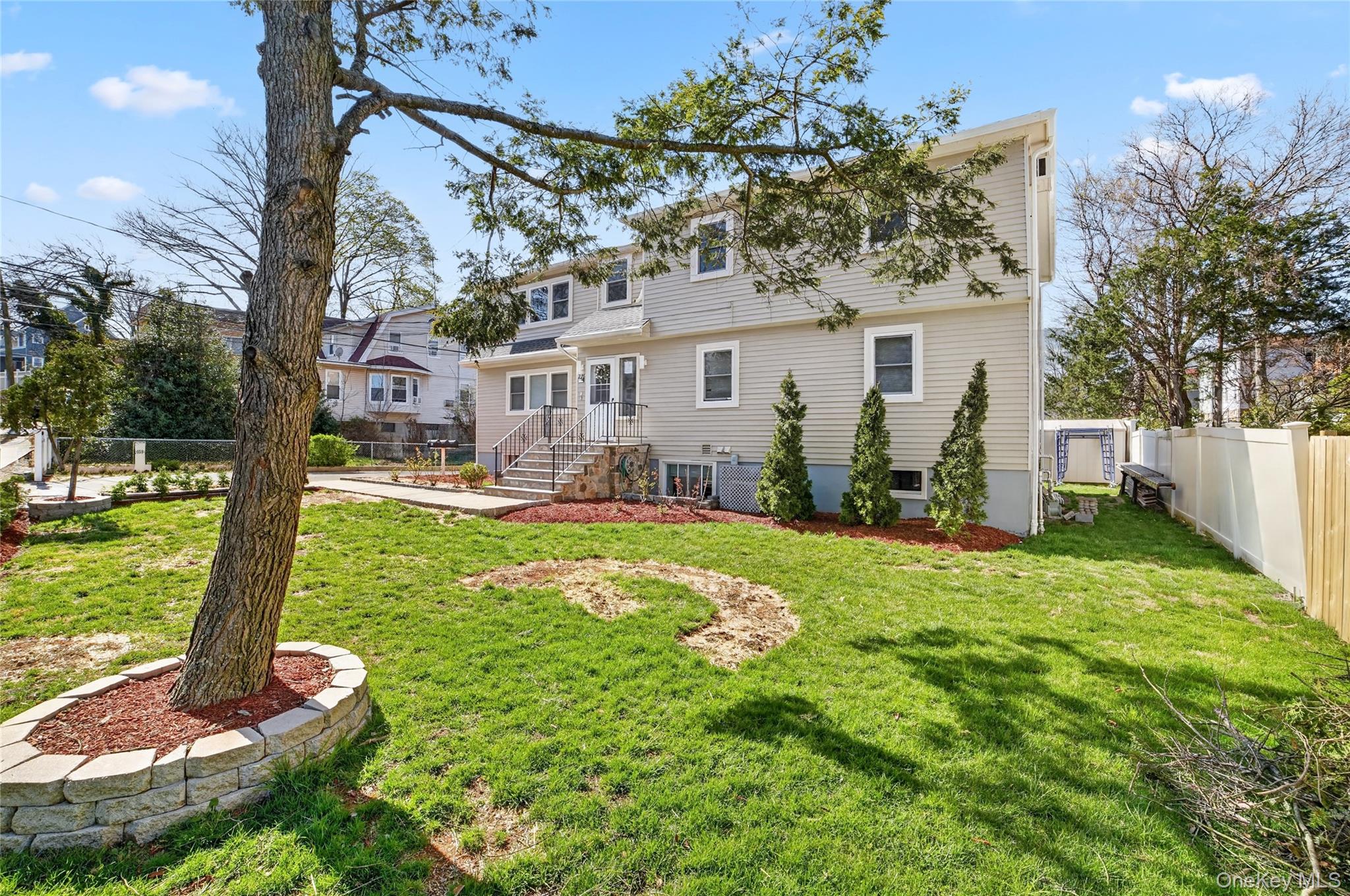 276 5th Avenue New Rochelle, NY 10801 - Photo 3 of 40 a front view of a house with a yard table and chairs
