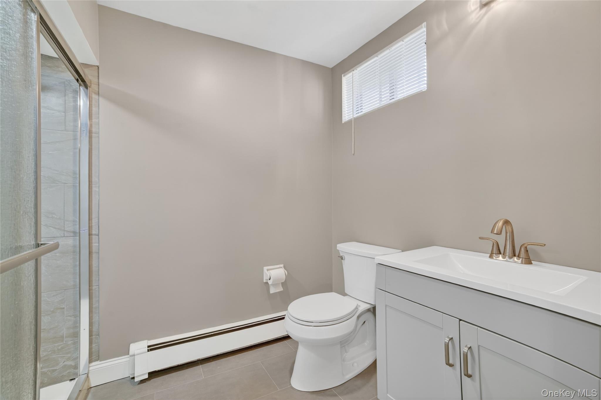 276 5th Avenue New Rochelle, NY 10801 - Photo 35 of 40 a bathroom with a toilet a sink and vanity