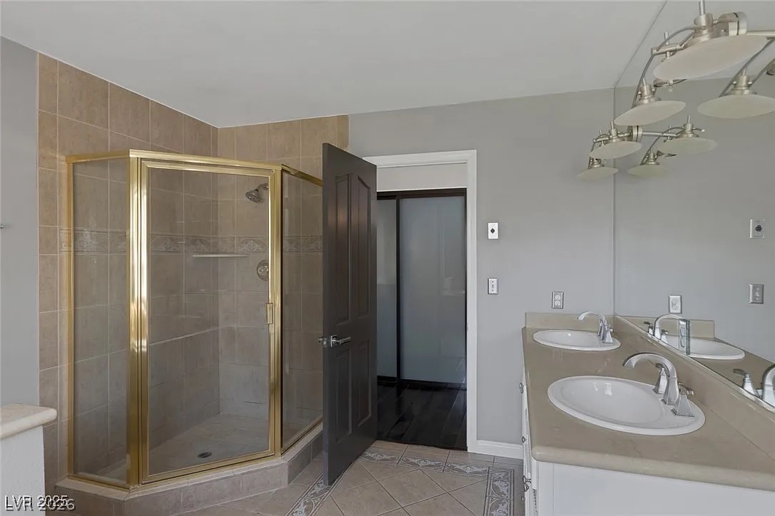 9 Quail Run Road Henderson, NV 89014 - Photo 29 of 57 Dual vanity sinks provide ample space for morning routines in this well-appointed bathroom.