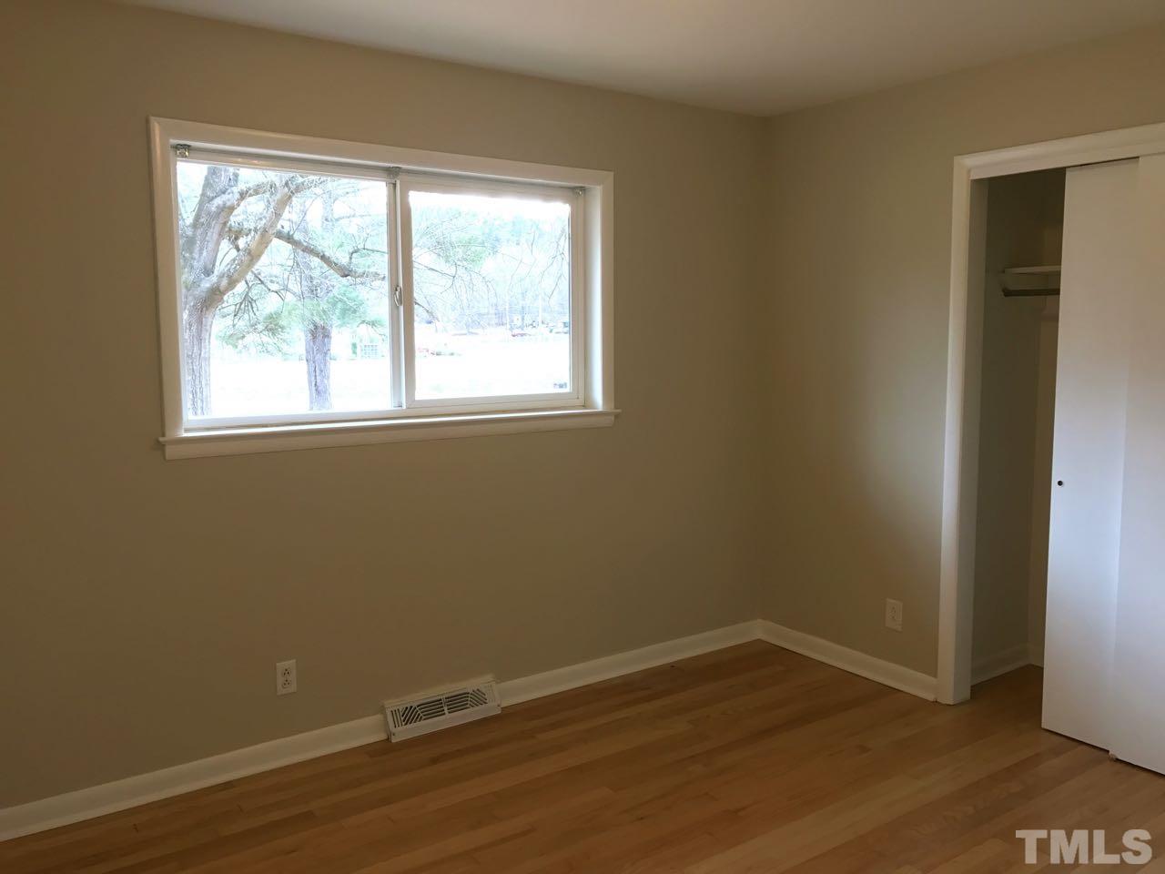 111 Barclay Road Durham, NC 27712 - Photo 11 of 21 an empty room with wooden floor and windows